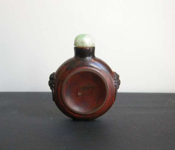 Rare snuff bottle carved wood with masks on the shoulders. each side carved in the shape of a tobacco cup